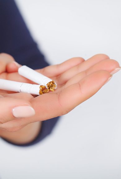 Stop Smoking. Beautiful Woman Breaking Cigarette In Half