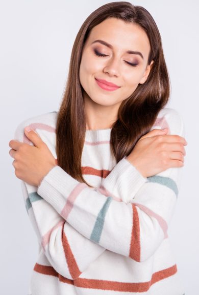 Photo of overjoyed lady, crossing hands touching nice striped pullover isolated white background